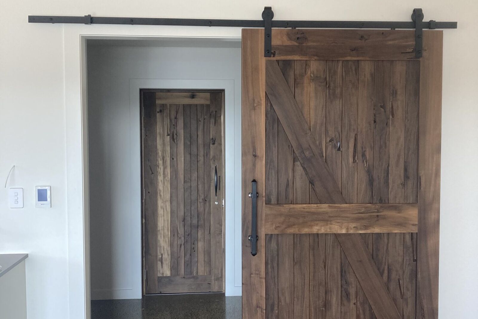 Custom timber barn door on a black rail
