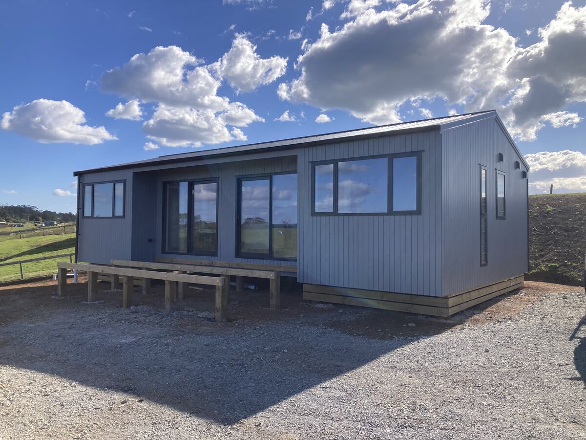 Completed transportable cabin under a big Northland sky