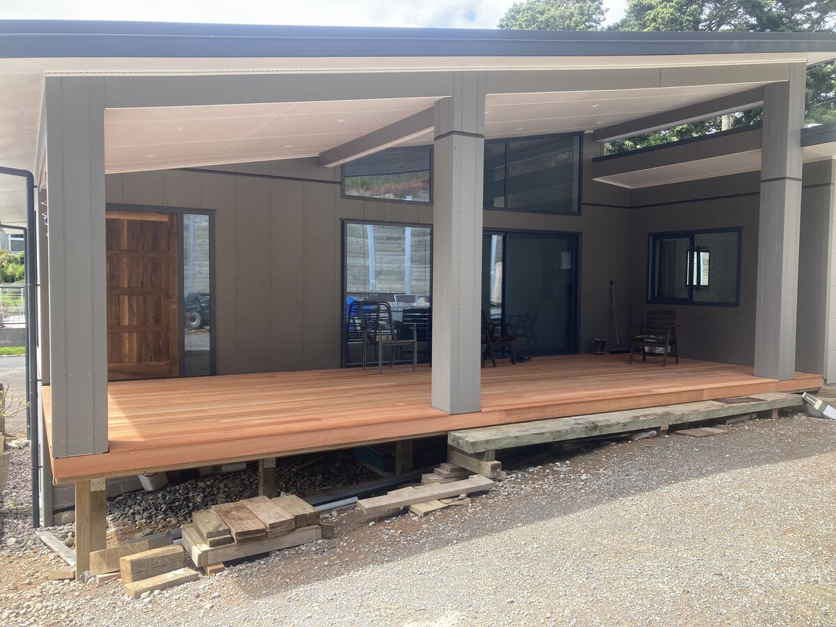 Covered deck and outdoor living area under a timber-lined roof