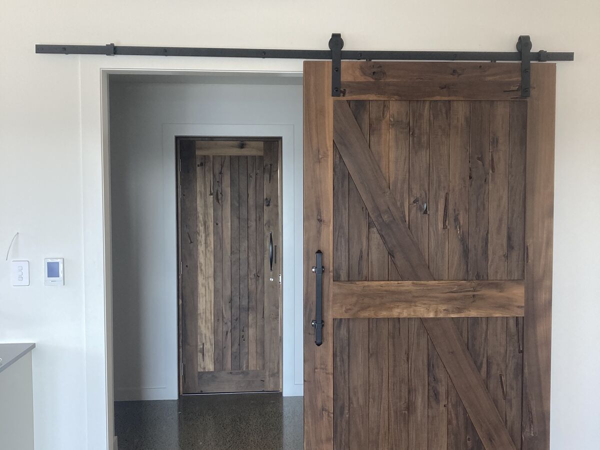 Custom timber barn door on a black rail
